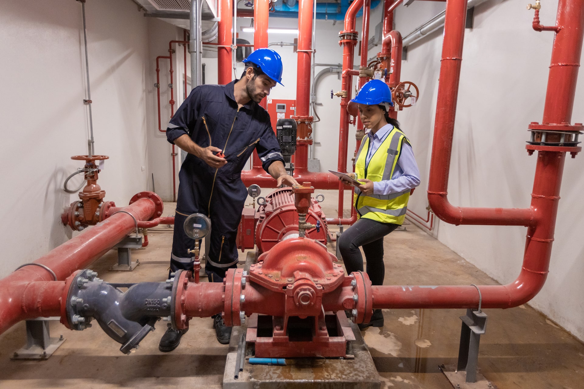 Engineer under checking the industry chilled water fan coil unit air conditioner is water cooling tower air chiller HVAC system of large industrial building to control air system